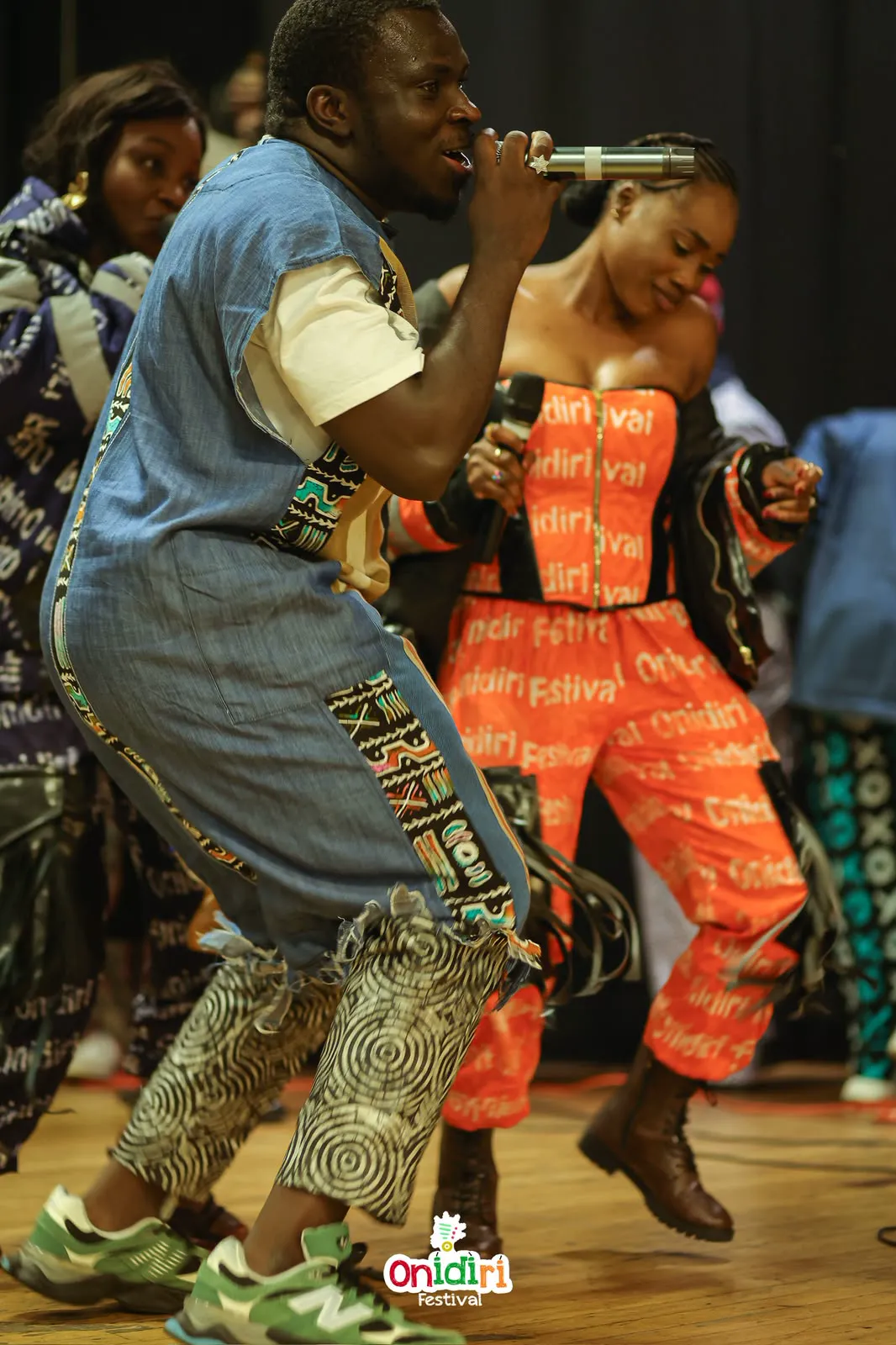 MC Crown dancing alongside a young participant during a festival performance